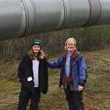 Bob and James stand in front of the pipeline.